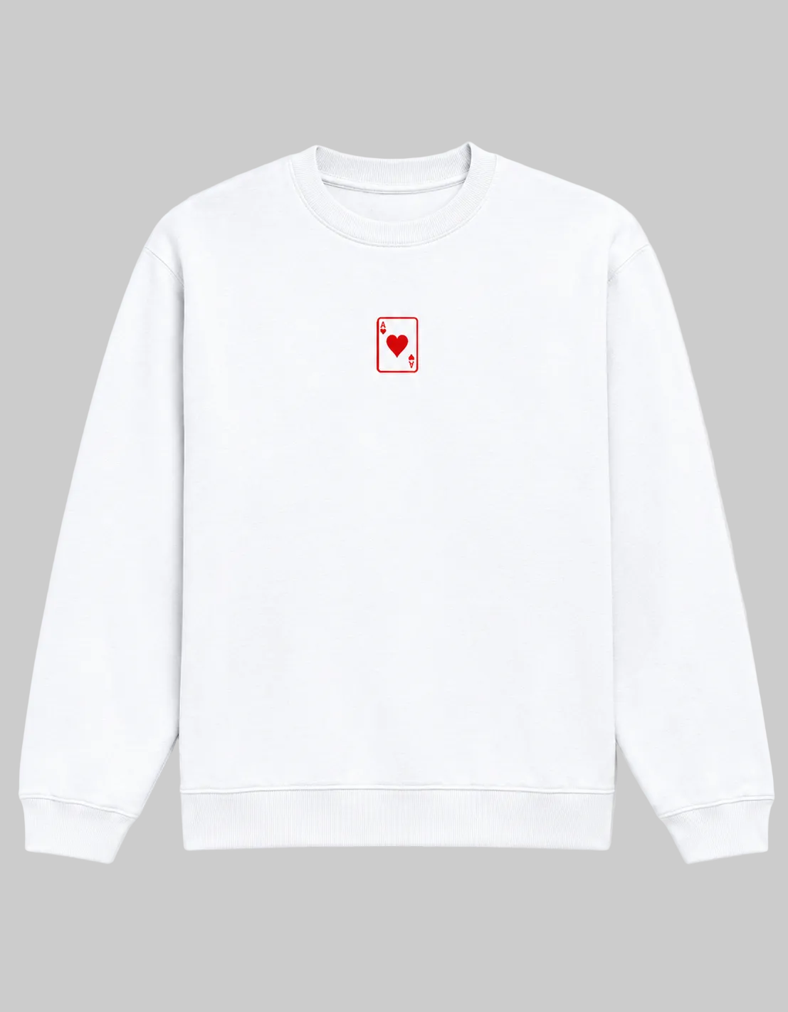 A white crewneck sweatshirt featuring a small red playing card (Ace of Hearts) graphic on the left chest, displayed against a clean white background.