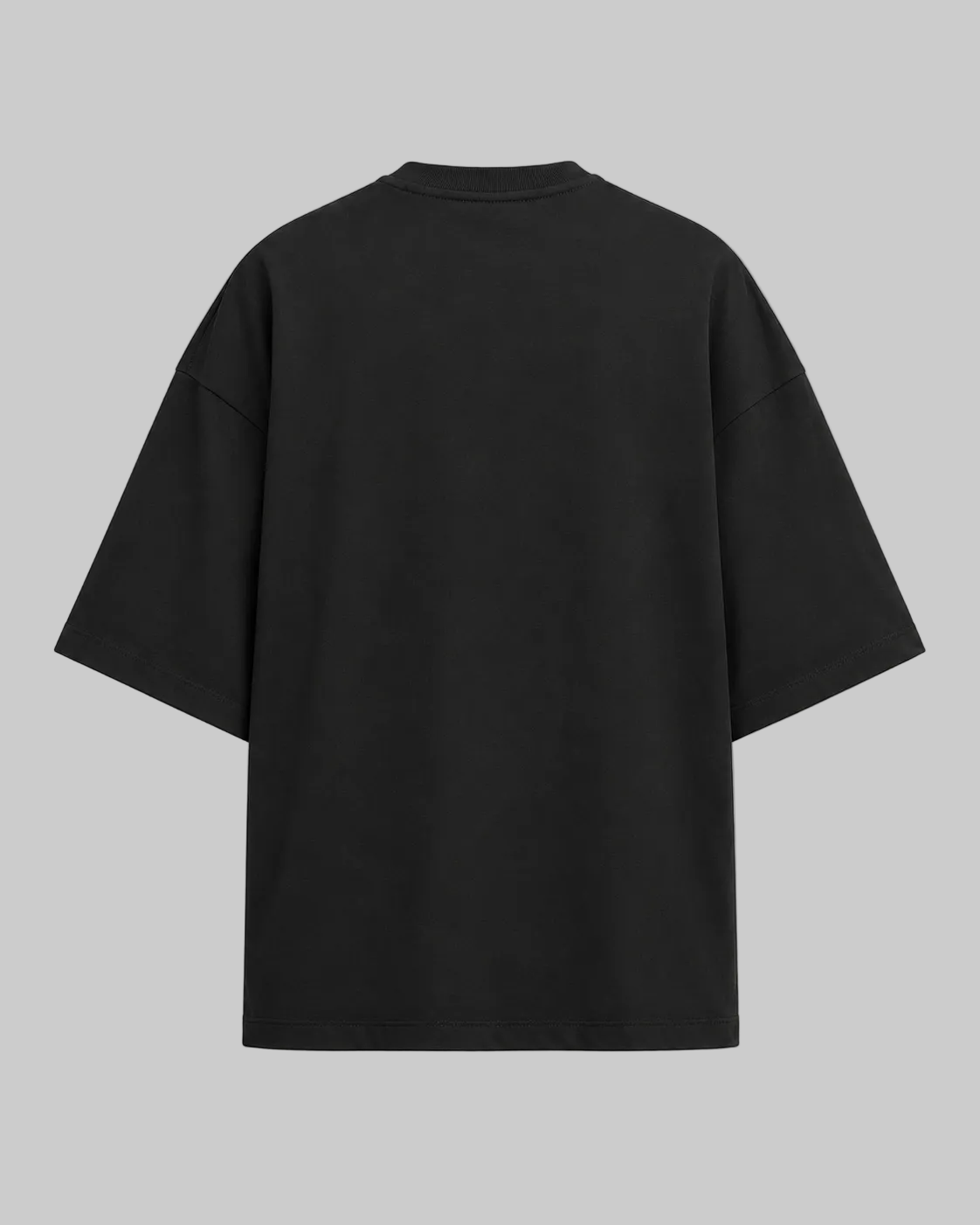 A black oversized short-sleeve t-shirt shown from the back, photographed against a clean, light off-white background.